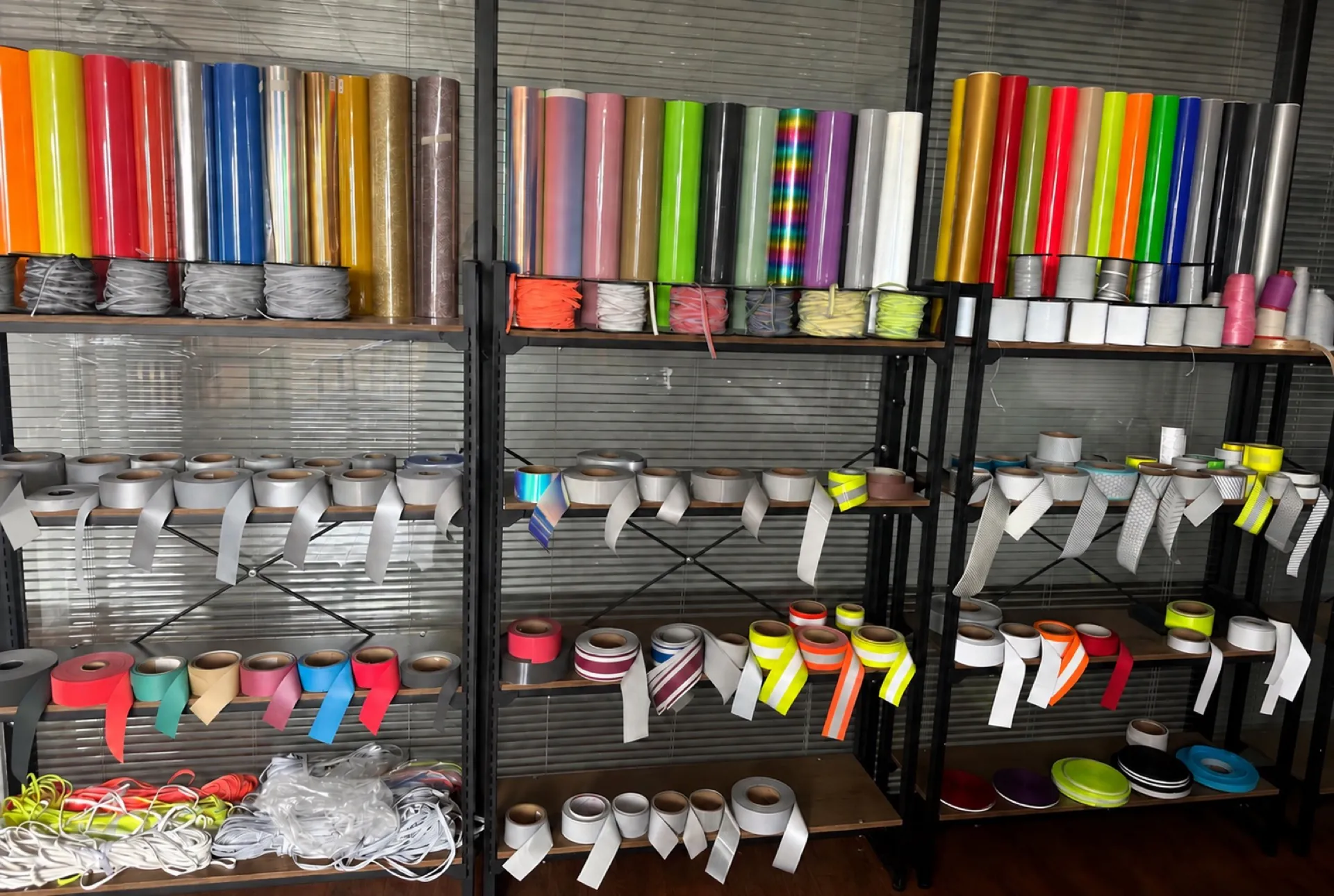 Material, reflective trim and accessory samples arranged on a factory display rack